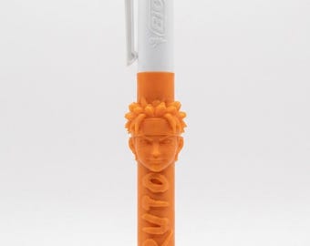 May include: A multi-color retractable ballpoint pen with a white top section featuring the BIC logo and four ink color selectors. The lower orange barrel features a 3D molded character head and the embossed text NARUTO vertically along the side.
