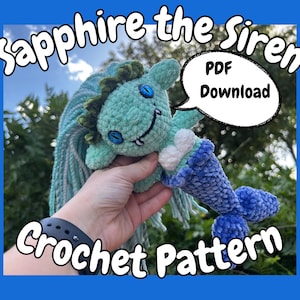May include: Crochet pattern for a teal and blue mermaid amigurumi toy named "Sapphire the Siren". The PDF download is available.