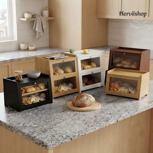 May include: A collection of four wooden bread boxes in black, natural wood, white, and dark brown finishes. Each box features a clear, ribbed glass front door with a small knob. The boxes are filled with various baked goods like rolls and loaves.