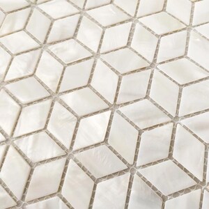 May include: A mosaic tile sheet featuring a repeating pattern of white, iridescent diamond-shaped pieces. Each individual tile has a smooth, pearlescent finish with subtle variations in tone, arranged in a geometric grid on a mesh backing.