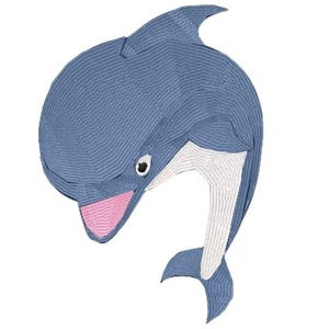 May include: An embroidered patch shaped like a dolphin in shades of blue, featuring a white underbelly, a pink snout, and a small black and white eye. The design is rendered with visible horizontal stitching throughout the entire surface area.