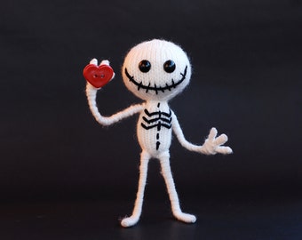 Jolly skeleton.  Knitting pattern (knitted in the round). Wire skeleton inside the lags and arms. Halloween pattern. Halloween decoration