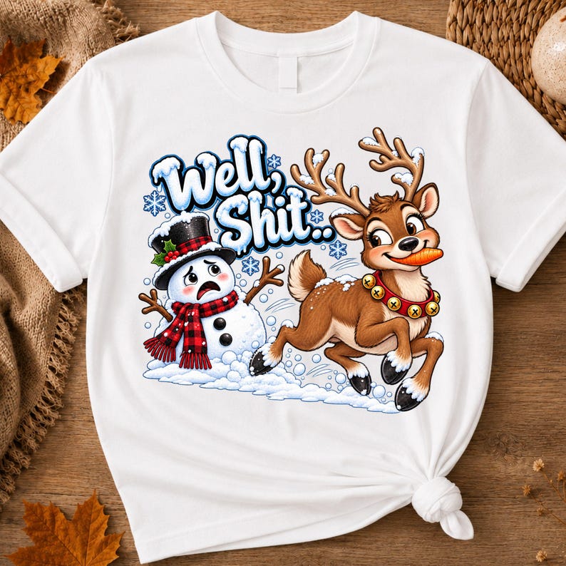 May include: A white t-shirt featuring a graphic of a distressed snowman wearing a black top hat and red plaid scarf, alongside a reindeer with a carrot in its mouth and a bell collar. The text "Well, Shit.." is printed in blue above them.