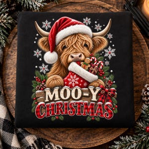 May include: A black t-shirt featuring a graphic of a fluffy Highland cow wearing a red Santa hat. The cow holds a red Christmas stocking filled with a gingerbread man and candy canes. Below, the text reads MOO-Y CHRISTMAS in bold letters.