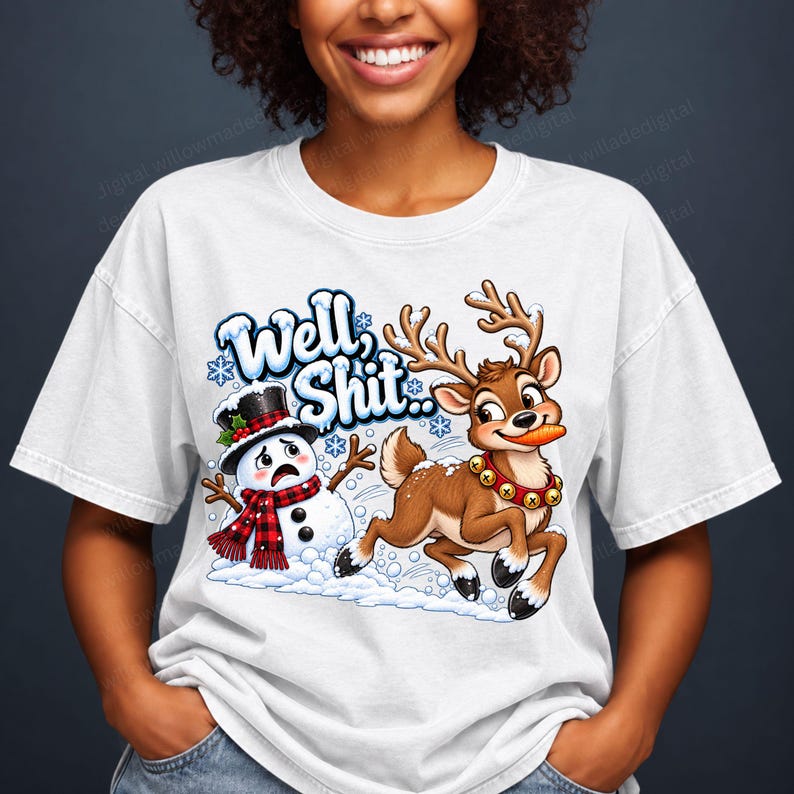 May include: A white t-shirt featuring a graphic of a distressed snowman wearing a black top hat and red plaid scarf, alongside a brown reindeer with a carrot in its mouth and a bell collar. The text "Well, Shit.." is printed above the characters.