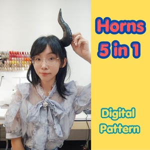 May include: A black curved horn accessory held up against the head. The image features text on a yellow background that reads Horns 5 in 1 Digital Pattern. The horn has a smooth, dark texture and a tapered, pointed shape, designed for costume use.