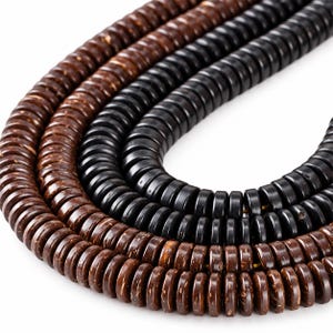 May include: A collection of three strands of circular, disc-shaped beads arranged in a nested U-shape. The outer and inner strands consist of dark brown, textured beads, while the middle strand features smooth, solid black beads.