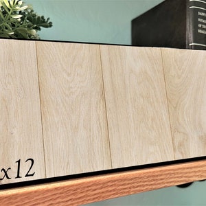 May include: A light wood panel with a black border and the text "5x12" printed on the bottom left corner.