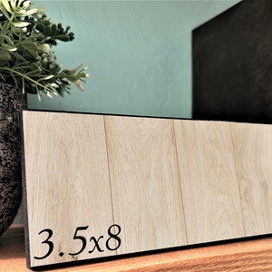 May include: A wooden sign with black trim and the text "3.5x8" printed on it.