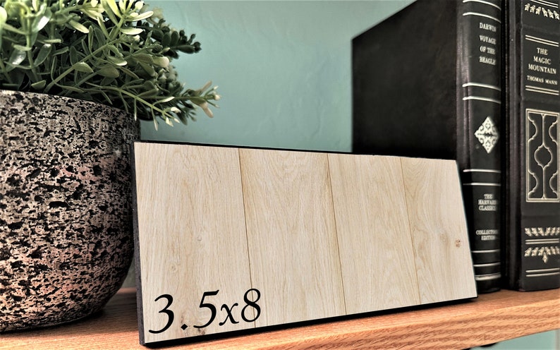 May include: A wooden sign with black trim and the text "3.5x8" printed on it.