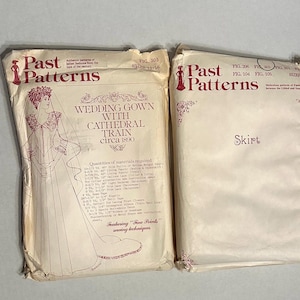 May include: Two beige paper sewing pattern envelopes by Past Patterns. The left envelope features a line drawing of a wedding gown with a cathedral train circa 1890 and lists material requirements. The right envelope is labeled Skirt.