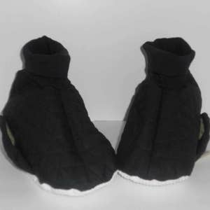 May include: A pair of black quilted slipper socks with white trim. The socks have a fold-over cuff at the top.