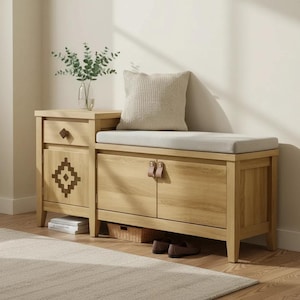 May include: A light wood storage bench featuring a single drawer with a geometric diamond pattern, two cabinet doors with leather pulls, and a light gray cushioned seat. A textured beige throw pillow sits on the bench next to a glass vase.