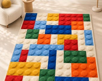 May include: A rectangular area rug featuring a raised, textured pattern of interlocking building blocks in primary colors including red, blue, yellow, green, and cream. The text BUILT FOR IMAGINATION, PLAYFUL COLOR, PREMIUM WOOL, HAND TUFTED, and DESIGNED FOR PLAY. CRAFTED TO LAST. is visible.