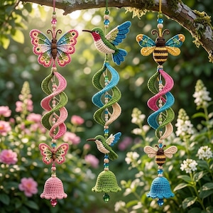 May include: Three hanging crochet ornaments featuring a butterfly, a hummingbird, and a bee. Each ornament includes a spiral crochet tail, smaller insect accents, and a crochet bell at the bottom, all connected by colorful beads and string.