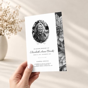 May include: A rectangular funeral program card featuring a black and white portrait of a person in an oval frame, floral border accents, and text reading In Loving Memory of Elizabeth Anne Brooks, March 14, 1942 - November 8, 2024, Funeral Service.
