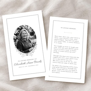 May include: Two white funeral memorial cards with black text and borders. The left card features an oval black and white portrait of Elizabeth Anne Brooks, with the text In Loving Memory of Elizabeth Anne Brooks, March 14, 1942 - November 8, 2024.