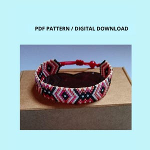 May include: A beaded bracelet featuring a geometric diamond pattern in red, white, and black, with a red cord closure. The text PDF PATTERN / DIGITAL DOWNLOAD is displayed above the bracelet, which is resting on a brown rectangular box.
