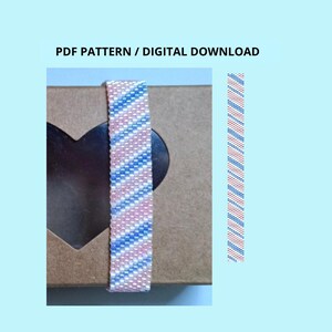 May include: A PDF pattern digital download featuring a beaded bracelet design with a diagonal striped pattern in light blue, white, and soft pink. The design is displayed on a brown box with a heart-shaped cutout and as a vertical strip.