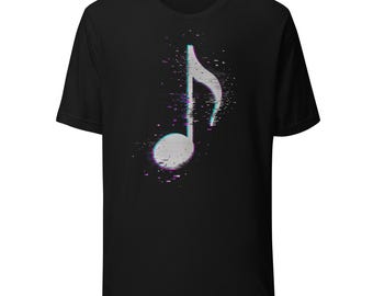 May include: A black short-sleeve t-shirt featuring a central graphic of a white musical note. The note design incorporates a digital glitch effect with scattered pixels and subtle cyan and magenta color shifts along its edges.