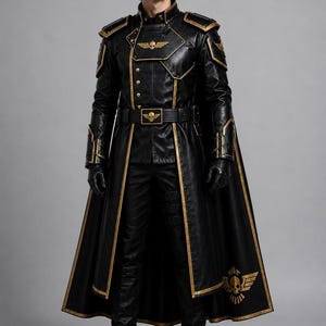 May include: A black long coat with gold trim, shoulder pads, and a high collar. The coat features a gold skull emblem on the chest and belt buckle, with a matching skull design on the lower hem. It is worn with black trousers and black gloves.