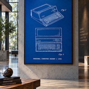 May include: A framed wall art print featuring a blue background with white line drawings of a personal computer patent from 1983. The text includes U.S. Patent, Apr. 12, 1983, Sheet 1 of 3, Des. 268,584, Fig. 1, Fig. 2, and PERSONAL COMPUTER PATENT | 1983.