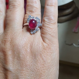 Natural huge striking color Ruby 925 white rhodium plated sterling silver ring. Size 8. Small aquamarines around
