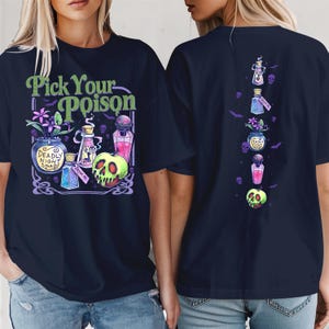 May include: A dark navy blue t-shirt featuring a graphic print with the text "Pick Your Poison" in green. The design includes a "Deadly Night Shade" potion bottle, a "Drink Me" bottle, a pink potion, and a green skull-patterned apple.