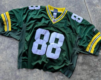 May include: Green football jersey with white number 88 on the front and back. The jersey has yellow and white stripes on the sleeves and collar. The NFL logo is visible on the neckline.