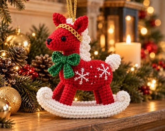 May include: A red crocheted rocking horse ornament featuring a white mane, tail, and rocker base. The horse has a green crocheted bow around its neck, a gold braided trim on its head, and white embroidered snowflake patterns on its body.