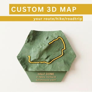 May include: A hexagonal 3D map of Half Dome featuring a green topographical landscape with a raised yellow route line. The base includes the text HALF DOME, 37.7459 N, 119.5332 W, and ELEVATION GAIN: 4,800 FT. The top banner reads CUSTOM 3D MAP.