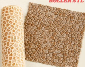 May include: A cylindrical texture roller with a raised grid pattern and a square sheet of brown material featuring an embossed stone-like texture. The image includes the red text "TEXTURE ROLLER STL" and "Digital Download".
