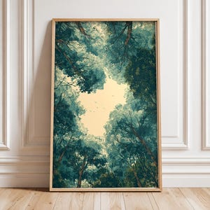 May include: A rectangular framed wall art print featuring a low-angle view of a dense forest canopy. The dark teal and green tree branches frame a central patch of pale yellow sky, with small silhouettes of birds visible in the distance.