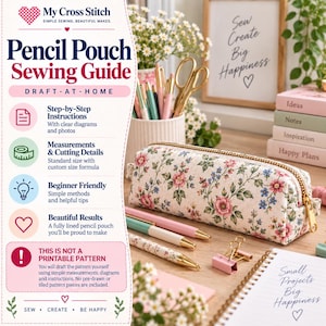 May include: A rectangular pencil pouch with a floral pattern featuring pink and blue flowers on a cream background, accented by a gold zip. The pouch is displayed alongside pens, gold binder clips, and a notebook with the text Small Projects Big Happiness.