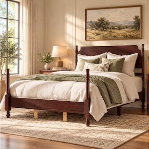 May include: A dark wood four-poster bed frame with a tall headboard and footboard, featuring turned posts. The bed is dressed with a white duvet, a thick olive green knit throw blanket, and several pillows in shades of white and olive green.
