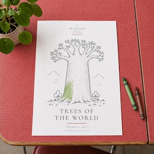 May include: A white coloring page titled "Worlds Worth Coloring" and "Trees of the World" featuring a black and white line drawing of a large baobab tree with a small patch of green crayon coloring on the trunk, accompanied by two crayons.