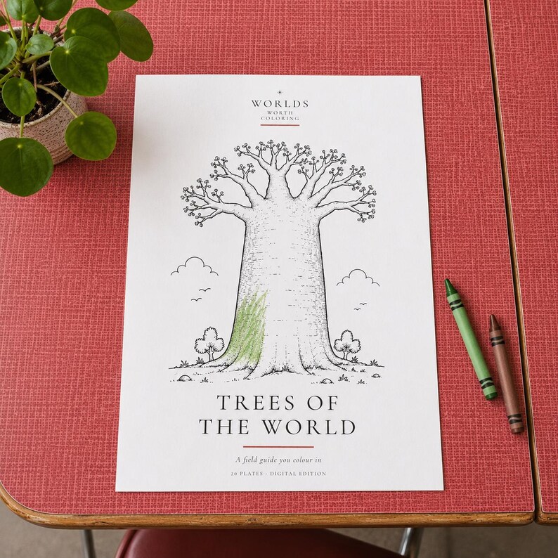 May include: A white coloring page titled "Worlds Worth Coloring" and "Trees of the World" featuring a black and white line drawing of a large baobab tree with a small patch of green crayon coloring on the trunk, accompanied by two crayons.
