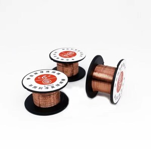 May include: Three spools of thin copper wire wound around black plastic bobbins. Each spool features a white circular label with red accents and black text, including the measurement 0.10mm, indicating the diameter of the metallic wire.