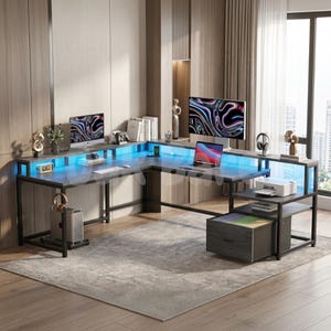 May include: An L-shaped desk with a dark wood finish and black metal frame, featuring integrated blue LED lighting, a raised monitor shelf, a lower storage shelf with a printer, a single pull-out drawer, and a dedicated tower computer stand.