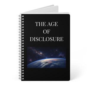 May include: A black spiral-bound notebook featuring the white text THE AGE OF DISCLOSURE centered on the cover. Below the text is a rectangular image depicting a view of Earth from space with a dark spacecraft hovering above the planet's atmosphere.