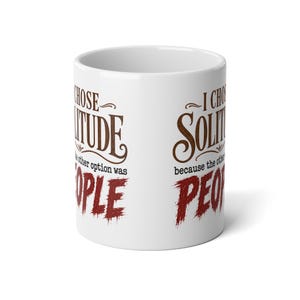 May include: A white ceramic mug featuring the brown text I CHOSE SOLITUDE and the smaller black text because the other option was, followed by the large red distressed text PEOPLE. The design is printed on the exterior of the cylindrical mug.