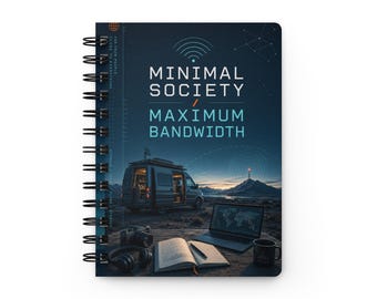 May include: A spiral-bound notebook with a dark blue cover featuring the text MINIMAL SOCIETY MAXIMUM BANDWIDTH. The cover art depicts a van parked in a landscape with a laptop, a camera, headphones, and an open book on a wooden surface.