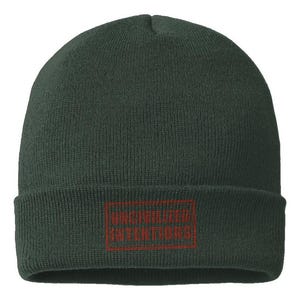 May include: A dark forest green knit beanie with a cuffed brim. Centered on the cuff is a rectangular patch featuring the text UNCIVILIZED INTENTIONS embroidered in a deep red thread, enclosed within a matching red rectangular border outline.