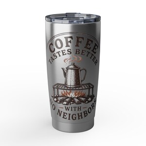 May include: A silver stainless steel tumbler with a clear plastic lid. The front features a dark brown graphic of a coffee pot on a campfire grill with the text "COFFEE TASTES BETTER WITH NO NEIGHBORS" printed in a circular layout around the design.