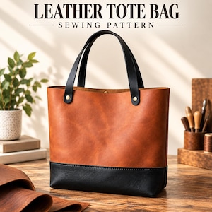Puede incluir: Un bolso tote de cuero color canela y negro con dos asas negras sujetas por remaches dorados. El texto LEATHER TOTE BAG SEWING PATTERN aparece en la parte superior. El bolso presenta una sección superior lisa color canela y una base negra.