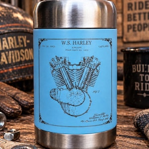 May include: A light blue cylindrical food jar with a brushed stainless steel lid and base. The front features a black technical drawing of a W.S. Harley engine patent, including the text Oct. 30, 1923, 1,472,068, and William S. Harley.