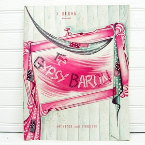 May include: A vintage program for the musical "The Gypsy Baron" presented by S. Hurok. The cover features a pink and white patchwork design with the title in a stylized font.