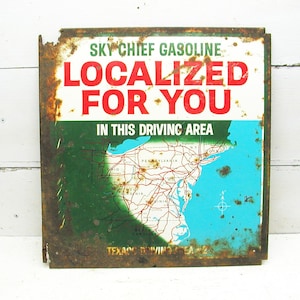 May include: A vintage, rusty metal sign advertising Sky Chief Gasoline. The sign features the text "Localized For You" in red letters and a map of the eastern United States with the text "In This Driving Area".
