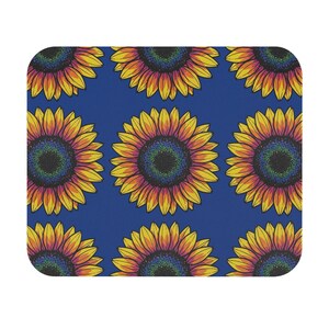 May include: A rectangular mouse pad featuring a repeating pattern of sunflowers with vibrant yellow and orange petals and dark, textured centers set against a solid, deep blue background. The design covers the entire surface of the item.