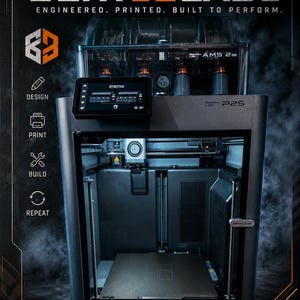 May include: A dark gray Bambu Lab P2S 3D printer with an AMS unit on top, featuring a touchscreen display, internal print bed, and the text BERT3DLABS ENGINEERED. PRINTED. BUILT TO PERFORM. PRECISION BY DESIGN PERFORMANCE BY PRINT on the frame.